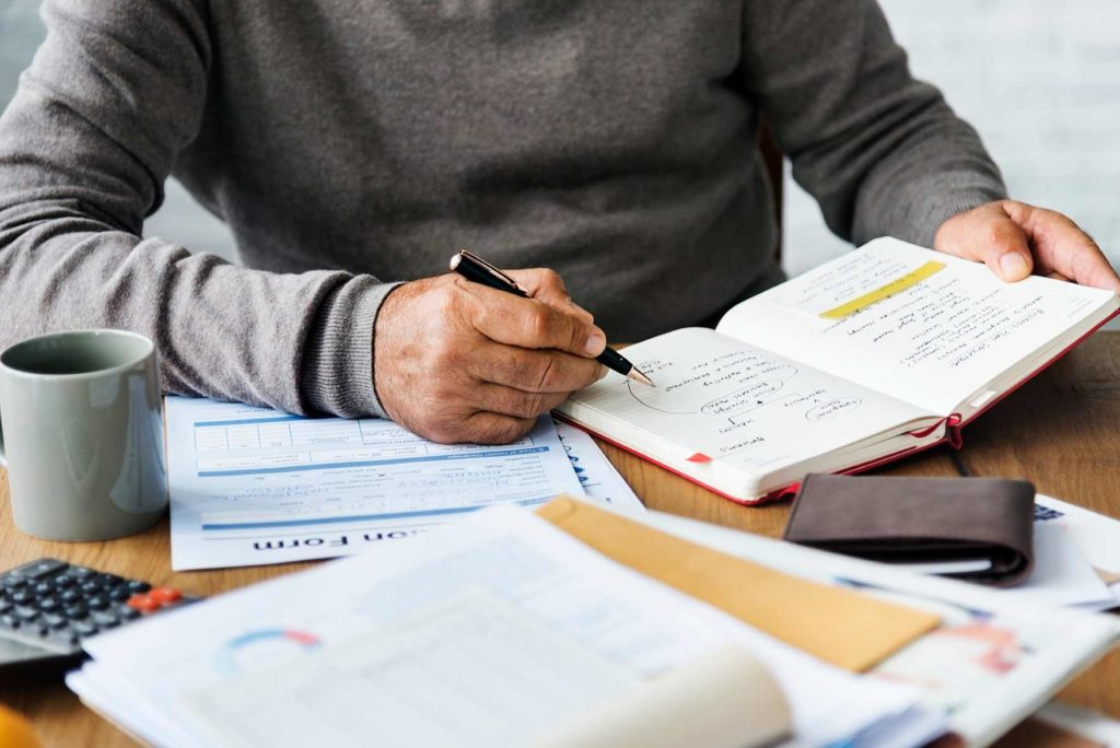 gentleman working on finances during coronavirus pandemic